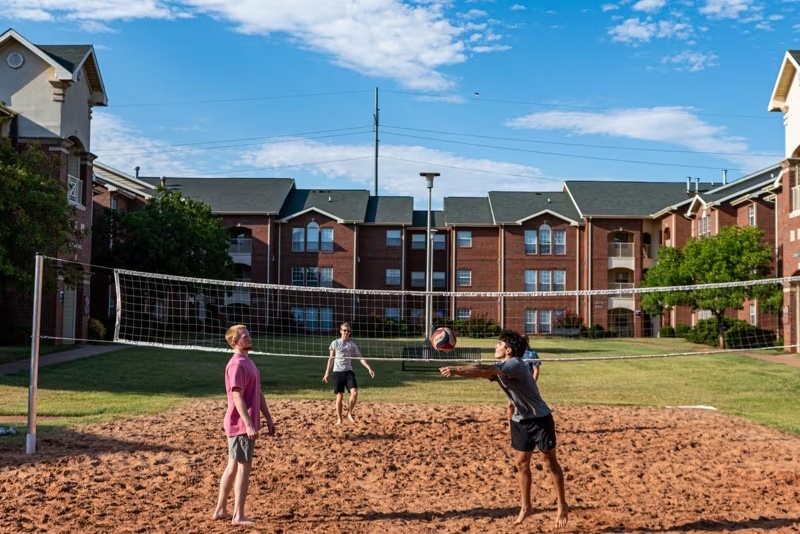 Students playing volleyball outside Bost hall