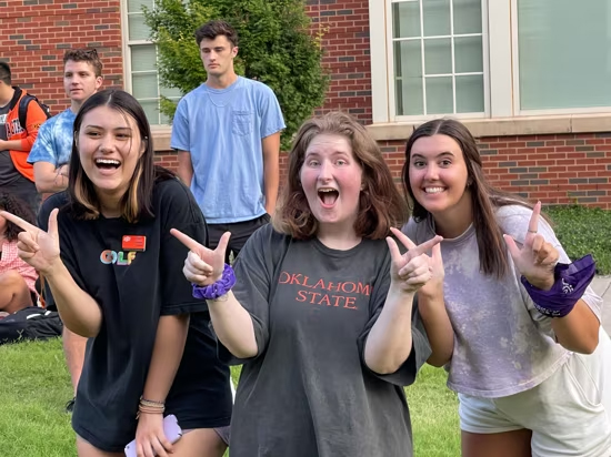 Students pose for group photo in front of dorm